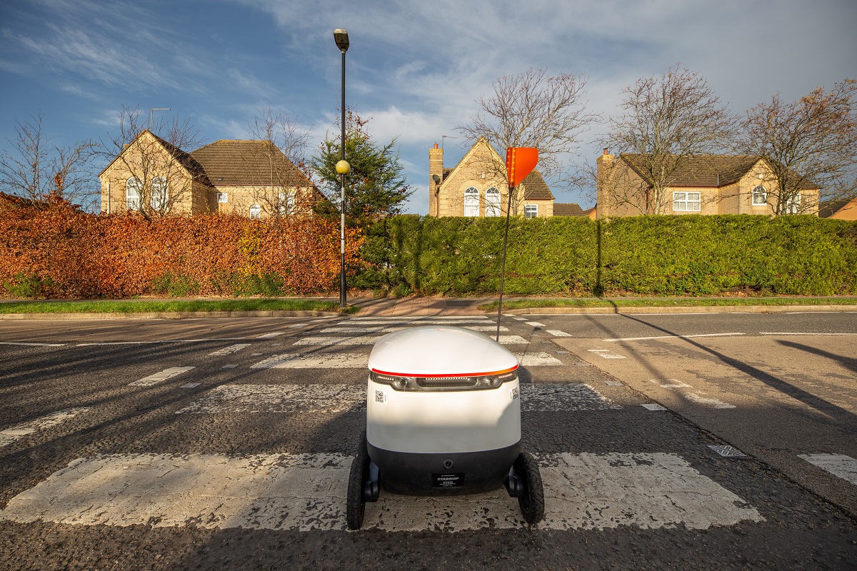 A Starship robot crosses the road in Northampton, UK